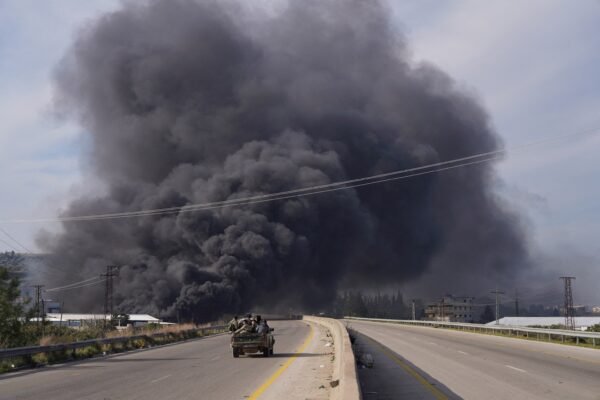 Hundreds of civilians informed murdered in massacres as violence in the spirals of Syria Photo: The smoke rises while the members of the Syrian forces travel in a vehicle in Latakia
