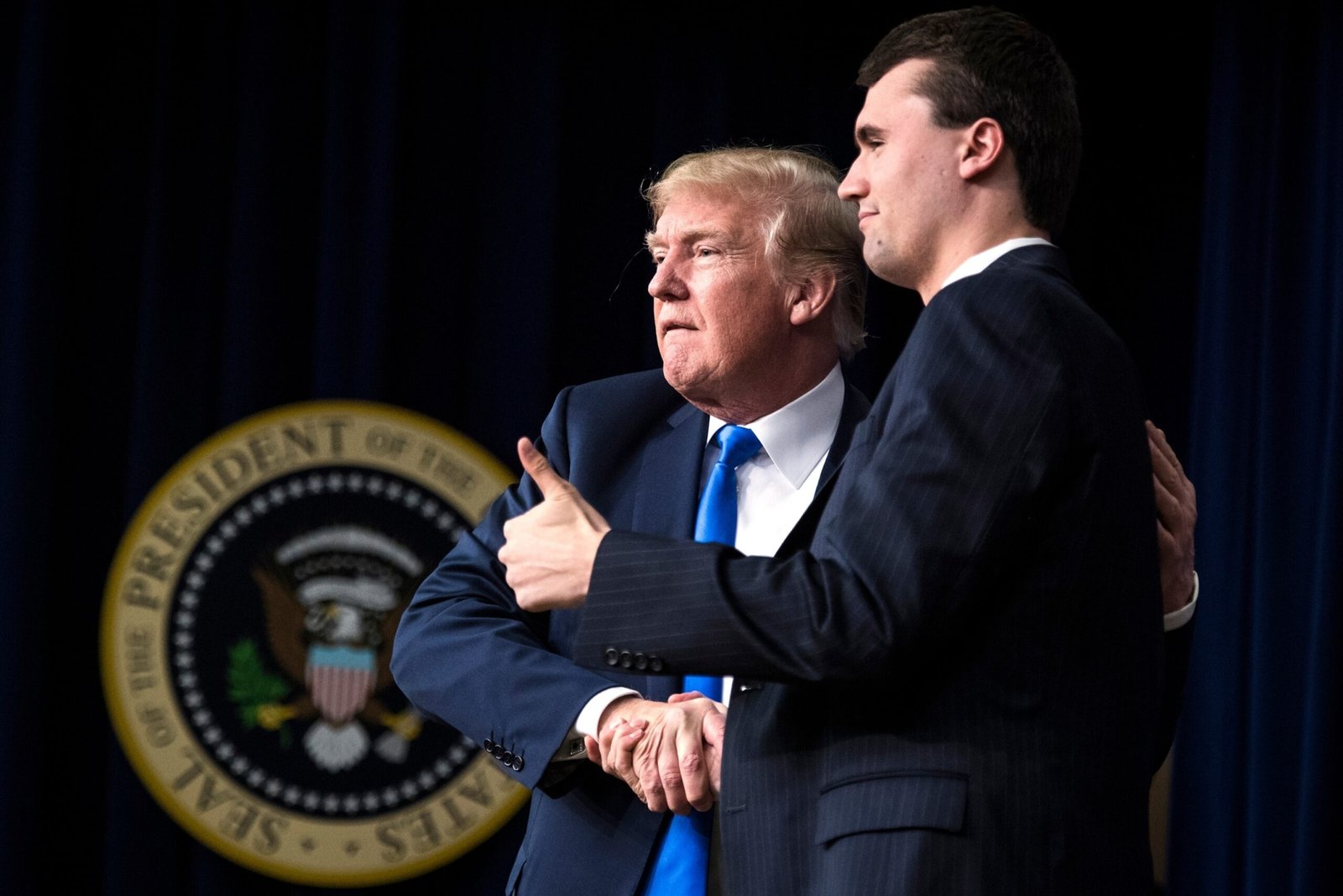 Photo: On March 22, 2018, File Photo, President Donald Trump shakes hand with Charlie Kirk, founder and executive director of Turning Point US
